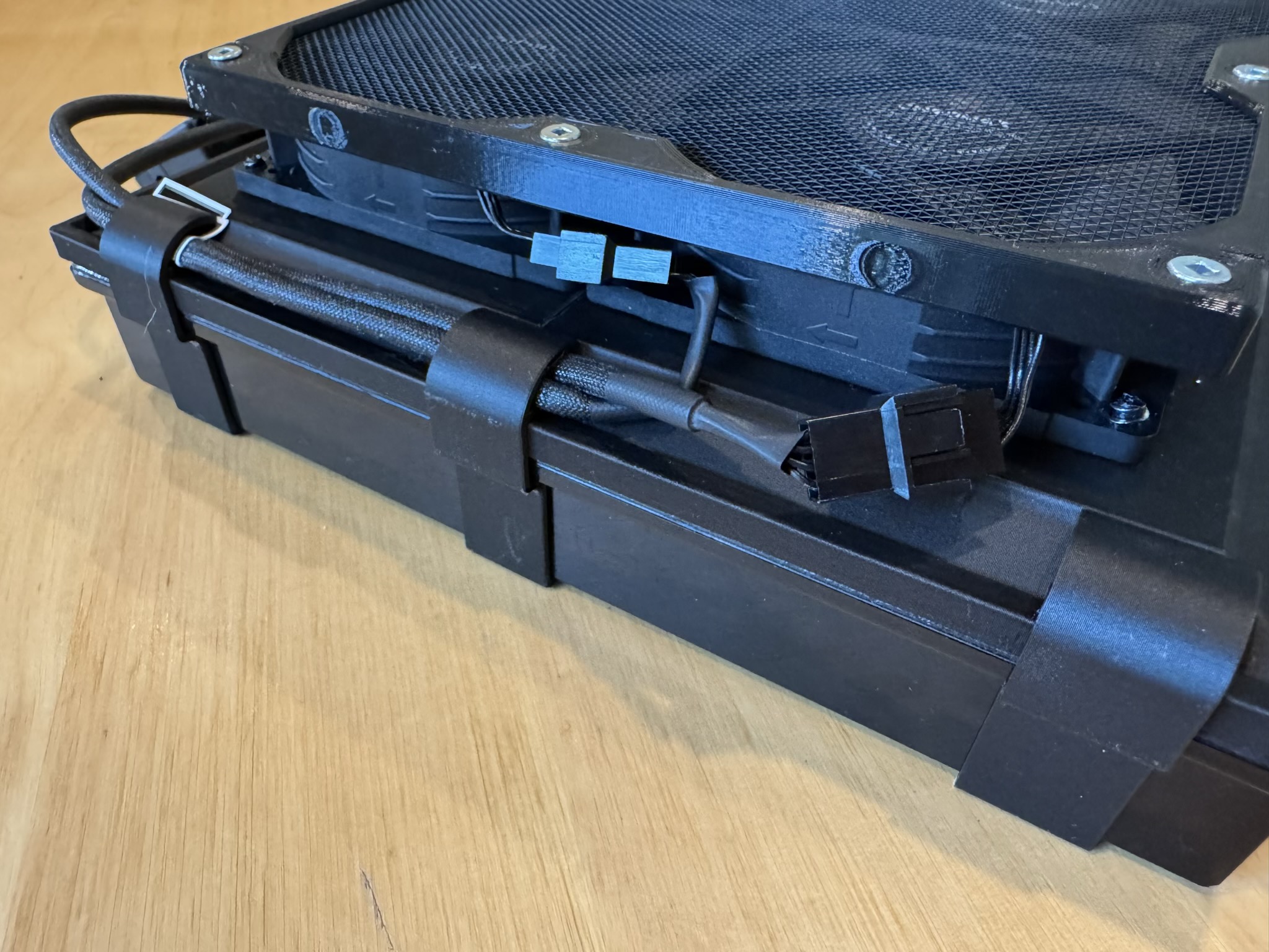 Side view of the assembly, showing cables routed through an extension of the clips that hold the filters on.