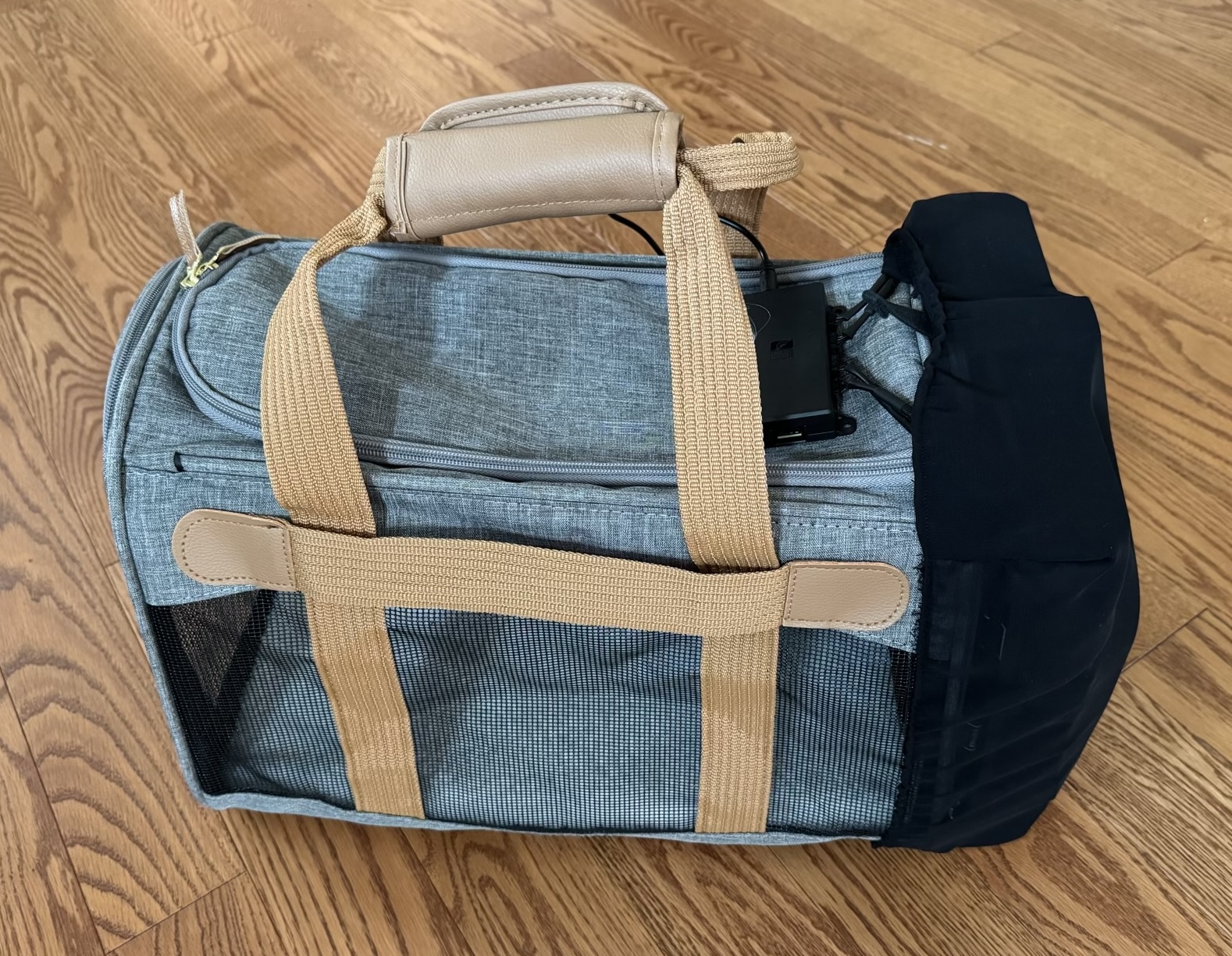 A side view from above of the cat carrier, showing the black shroud on the right and power distribution peeking out on the top.